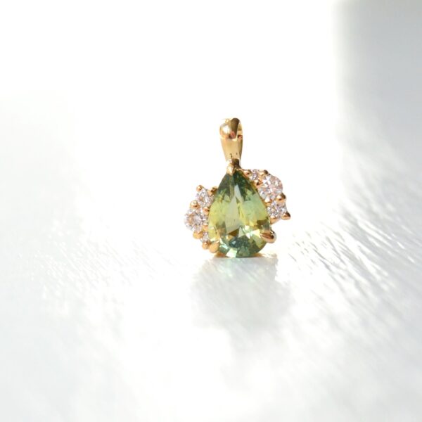 green sapphire pendant with diamonds set in 18K yellow gold.